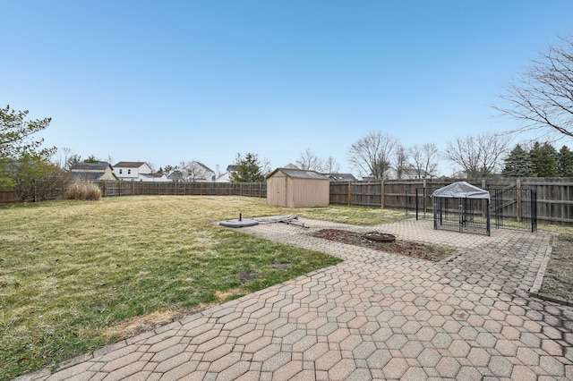 view of yard featuring a fenced backyard, a patio, and an outdoor structure