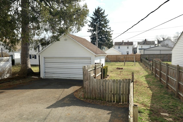 detached garage featuring fence