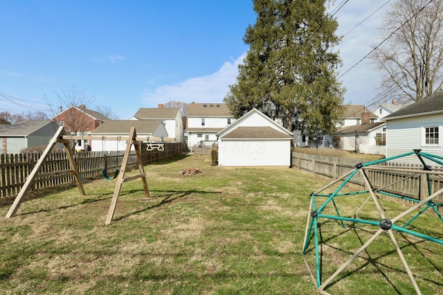 view of yard featuring a residential view, a playground, and a fenced backyard