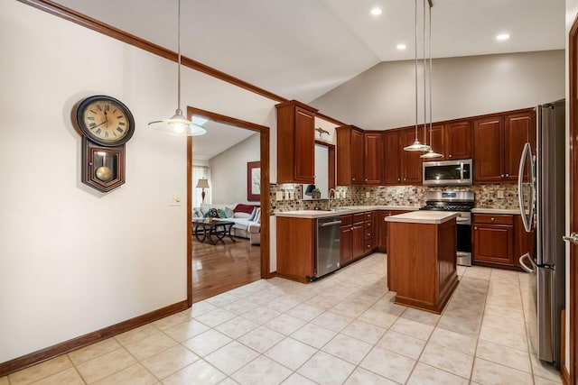 kitchen with tasteful backsplash, appliances with stainless steel finishes, a center island, light countertops, and a sink