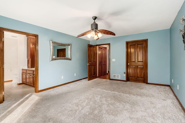 unfurnished bedroom with light carpet, visible vents, and baseboards