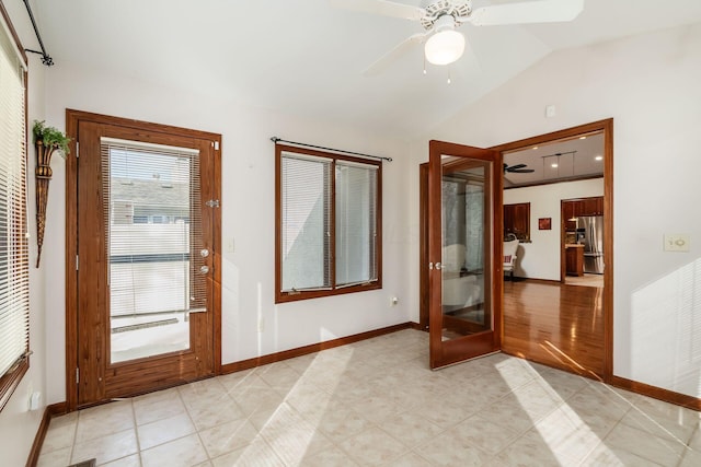 doorway to outside with lofted ceiling, light tile patterned floors, baseboards, and a ceiling fan