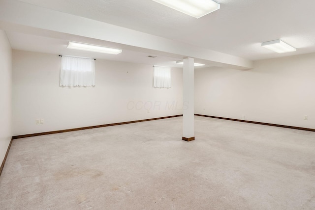 basement with baseboards and carpet flooring