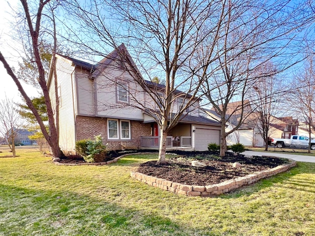 view of front of property with a front lawn, brick siding, and a garage