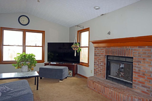 living area featuring lofted ceiling, a brick fireplace, carpet flooring, a textured ceiling, and baseboards