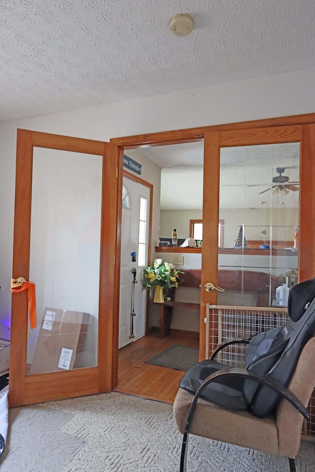 entryway with a textured ceiling and wood finished floors