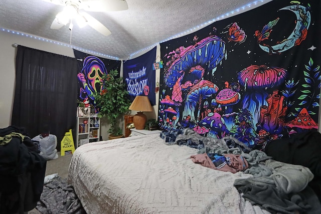 carpeted bedroom with a ceiling fan and a textured ceiling