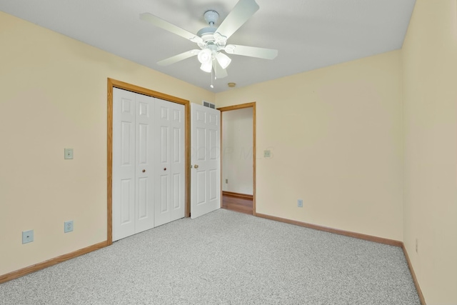 unfurnished bedroom featuring carpet, a closet, visible vents, a ceiling fan, and baseboards