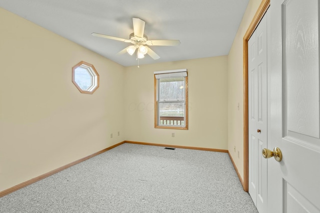 unfurnished bedroom featuring a closet, carpet flooring, visible vents, and baseboards