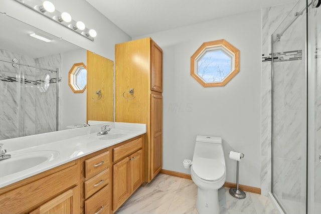 bathroom featuring toilet, marble finish floor, and a sink