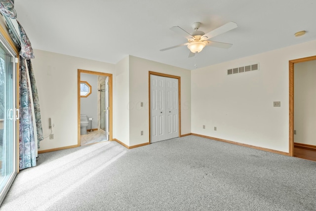 unfurnished bedroom with carpet floors, a closet, visible vents, a ceiling fan, and baseboards