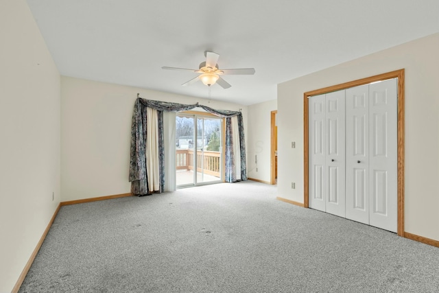 unfurnished bedroom with access to outside, carpet, a ceiling fan, and baseboards