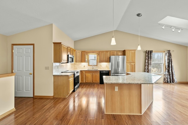 kitchen with appliances with stainless steel finishes, a sink, backsplash, and light stone counters