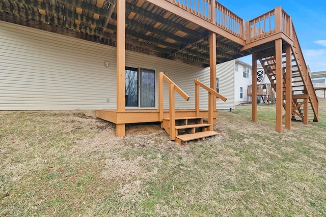 exterior space featuring a wooden deck, stairway, and a yard