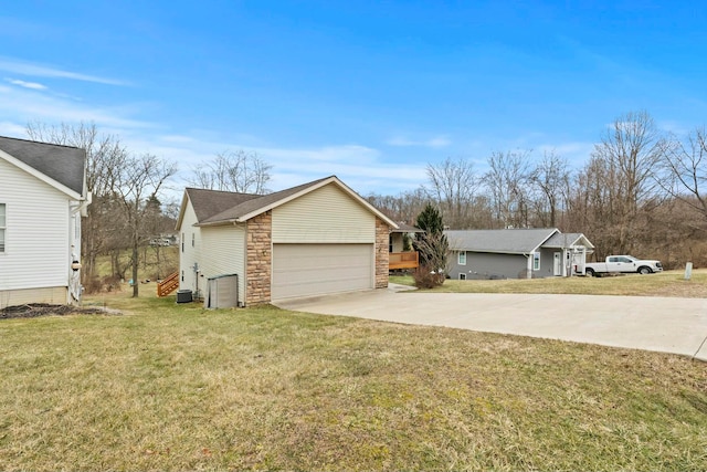 view of front of property with a garage, stone siding, driveway, and a front lawn