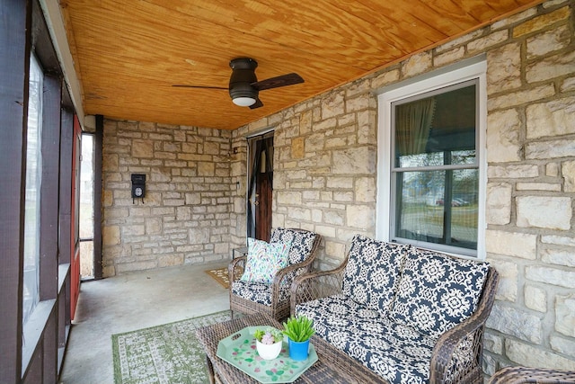 unfurnished sunroom with wooden ceiling and a ceiling fan