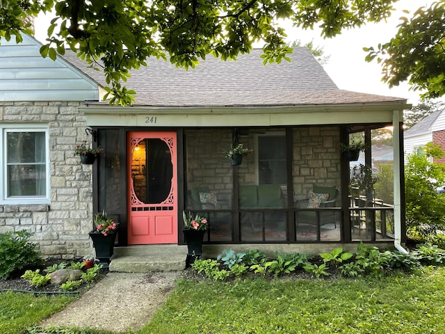 property entrance with stone siding and a shingled roof