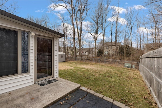 view of yard with a patio, an outdoor structure, and a fenced backyard