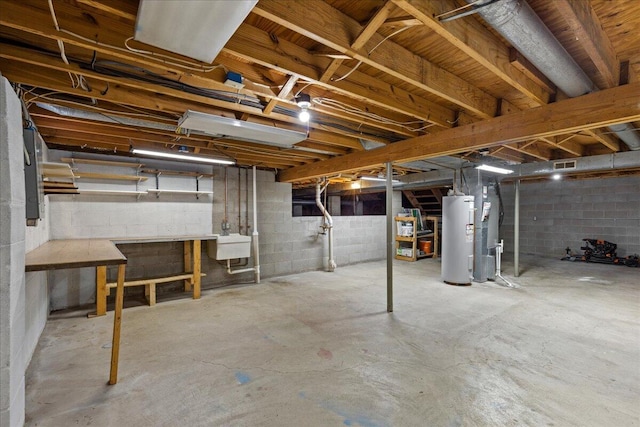 unfinished basement featuring a sink and electric water heater