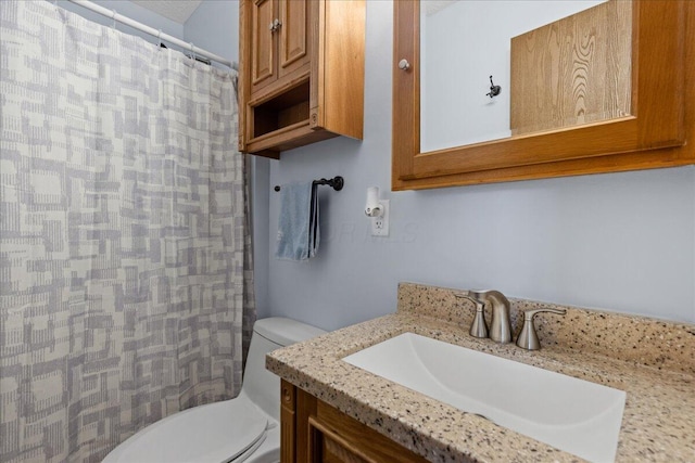 full bathroom featuring curtained shower, vanity, and toilet