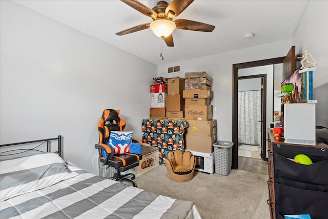 carpeted bedroom featuring visible vents and a ceiling fan