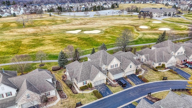 drone / aerial view with a residential view and golf course view