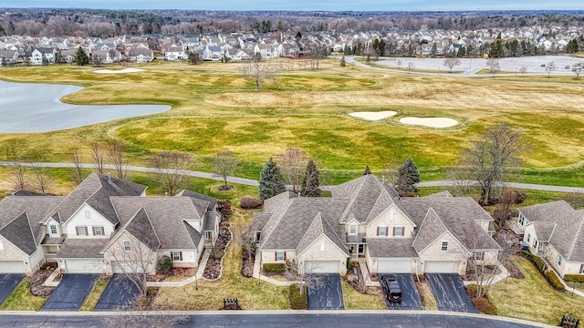 bird's eye view featuring golf course view, a water view, and a residential view