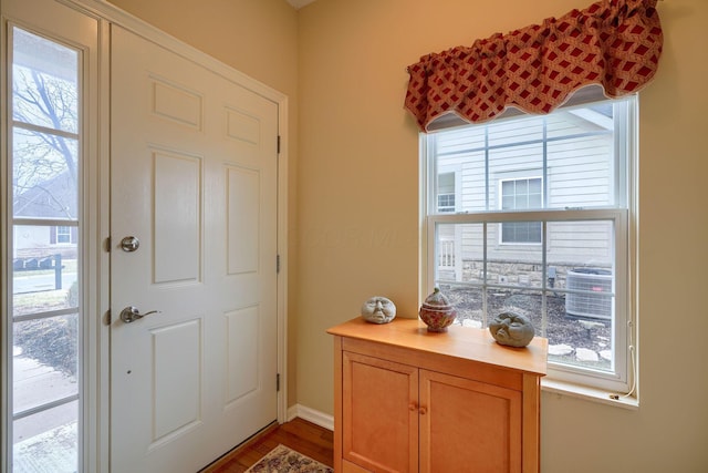 doorway to outside with a healthy amount of sunlight and wood finished floors