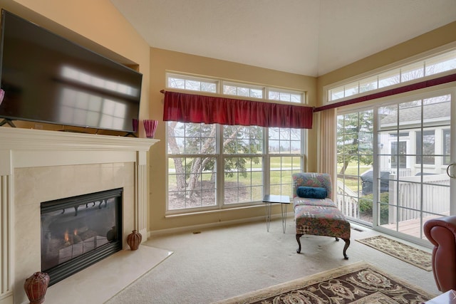 sunroom / solarium with vaulted ceiling and a tile fireplace