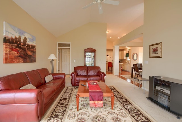 carpeted living room with vaulted ceiling, decorative columns, and ceiling fan