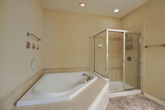 full bath with a stall shower, recessed lighting, and a bath