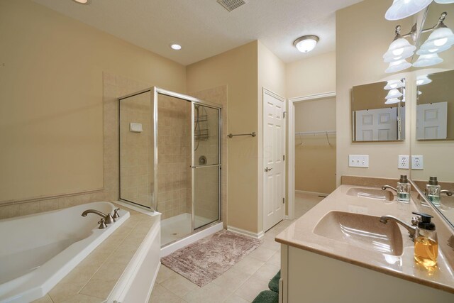 full bathroom featuring tile patterned flooring, a garden tub, a sink, and a shower stall