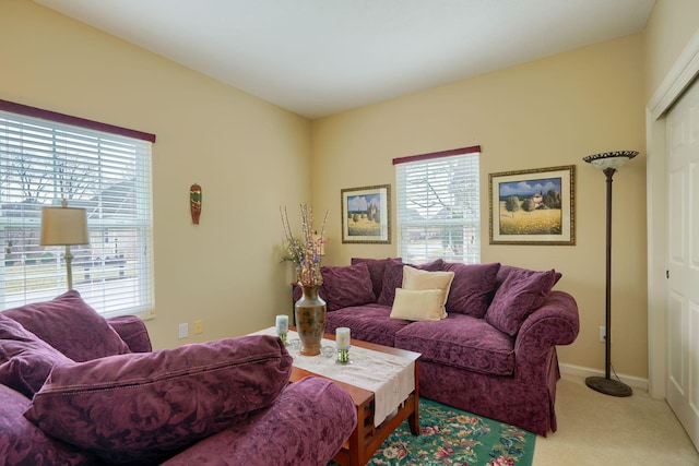 living room with light carpet and baseboards