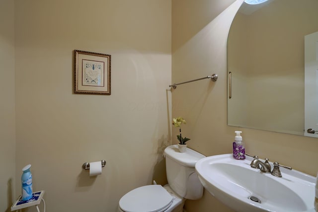 half bath featuring a sink and toilet