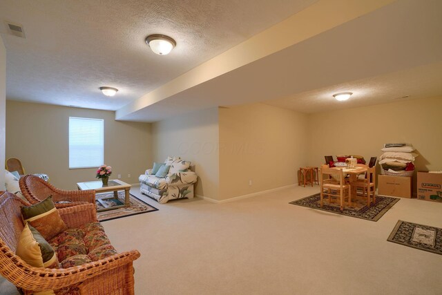 game room with carpet, visible vents, a textured ceiling, and baseboards