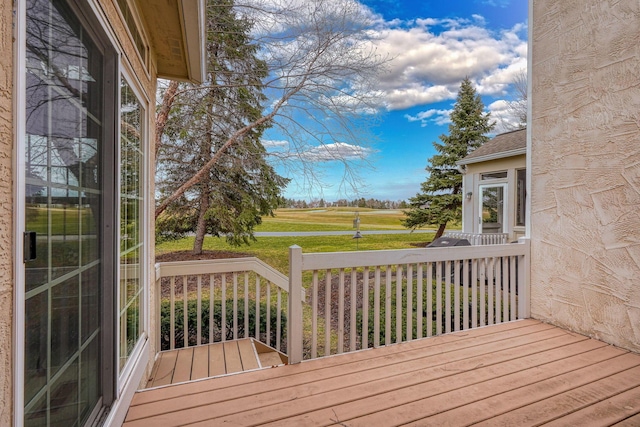 wooden terrace with a lawn