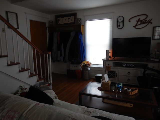 living area with stairway and wood finished floors