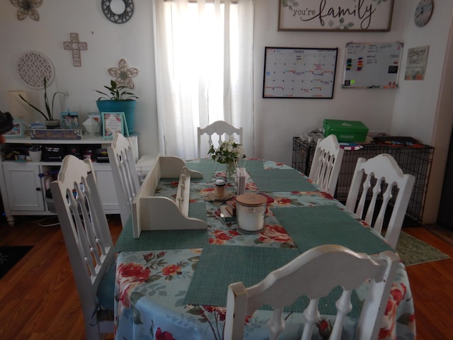 dining area with wood finished floors