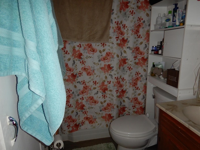 full bathroom with wallpapered walls, a shower with curtain, toilet, and vanity