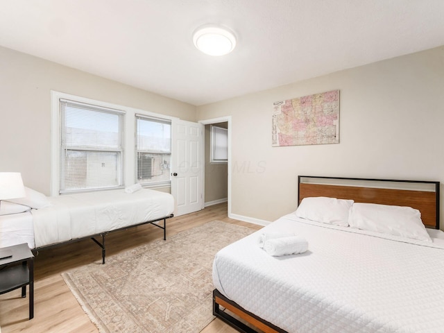 bedroom featuring wood finished floors and baseboards