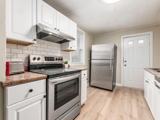 kitchen featuring tasteful backsplash, appliances with stainless steel finishes, light wood-style floors, white cabinetry, and under cabinet range hood