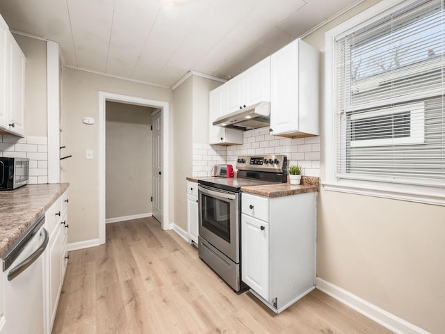 kitchen with stainless steel appliances, tasteful backsplash, white cabinetry, light wood-type flooring, and under cabinet range hood