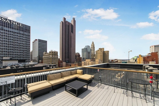 wooden terrace featuring a view of city and outdoor lounge area