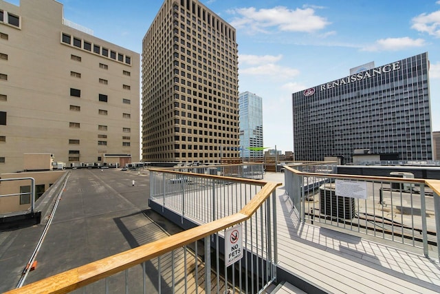 wooden terrace featuring a city view