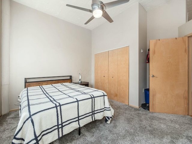 bedroom with high vaulted ceiling, carpet, a closet, and ceiling fan