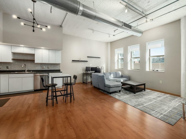 living room featuring rail lighting and wood finished floors