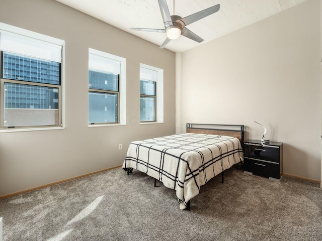 carpeted bedroom with a ceiling fan and baseboards