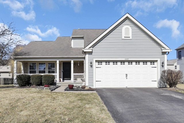 view of front facade with aphalt driveway, a porch, a front yard, and a garage