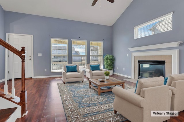 living area featuring a wealth of natural light, dark wood-type flooring, and baseboards