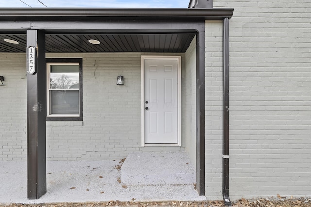 property entrance featuring brick siding